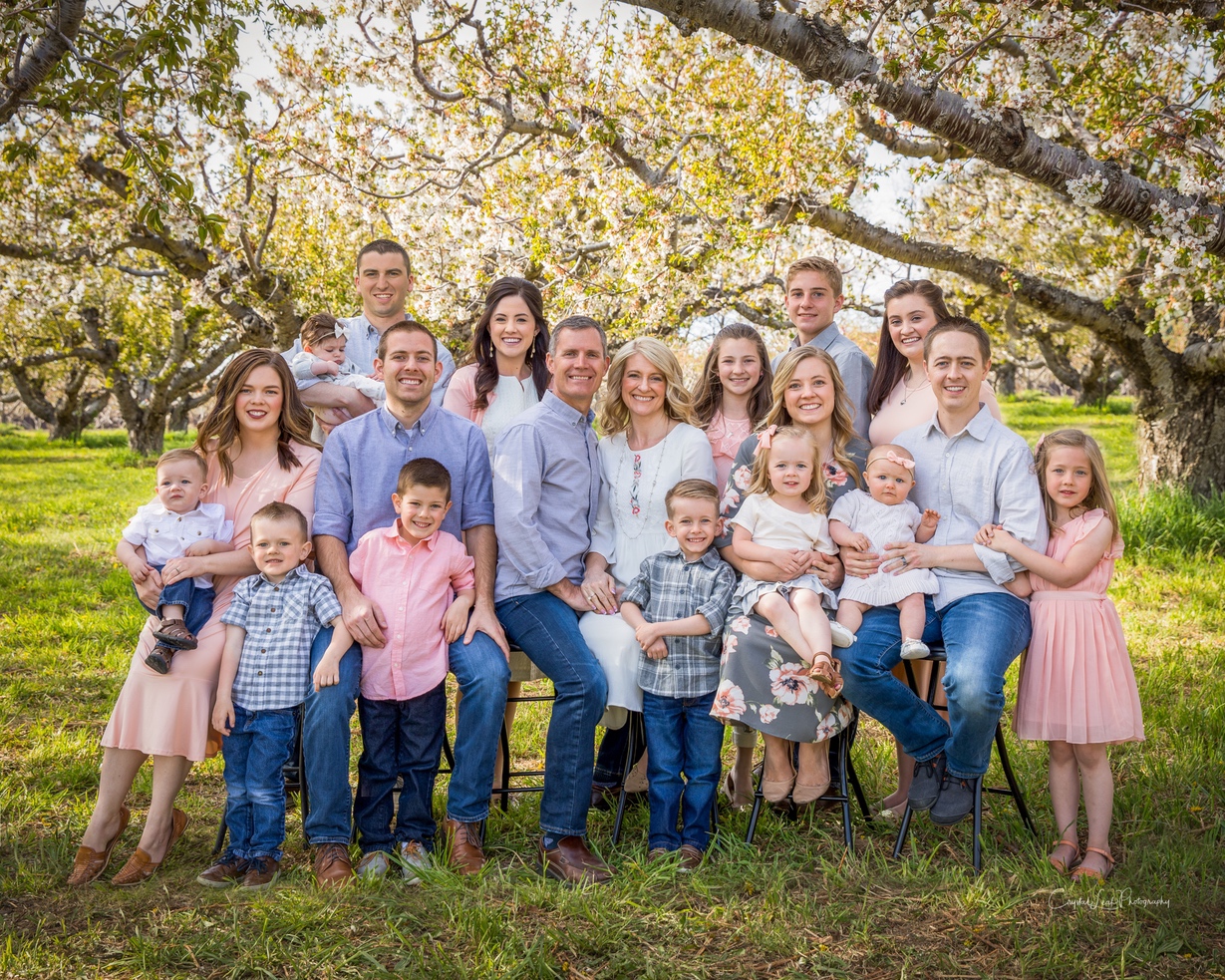 Photo of beautiful family in an orchard